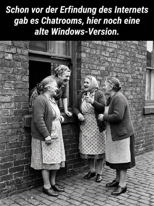 Eine alte Frau lehnt sich aus dem Fenster zur Straße. Dort stehen noch drei weitere alte Frauen. Alle reden miteinander.